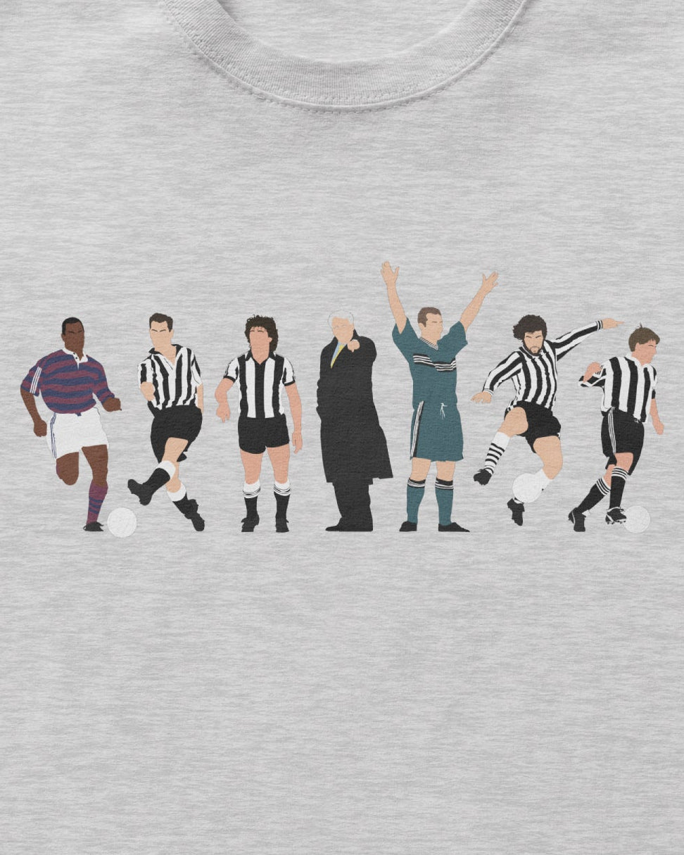 A light heather gray crewneck t-shirt featuring a graphic print of soccer players in various team uniforms on the chest, displayed against a light gray background.